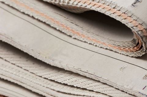 The folded edge of a stack of newspapers